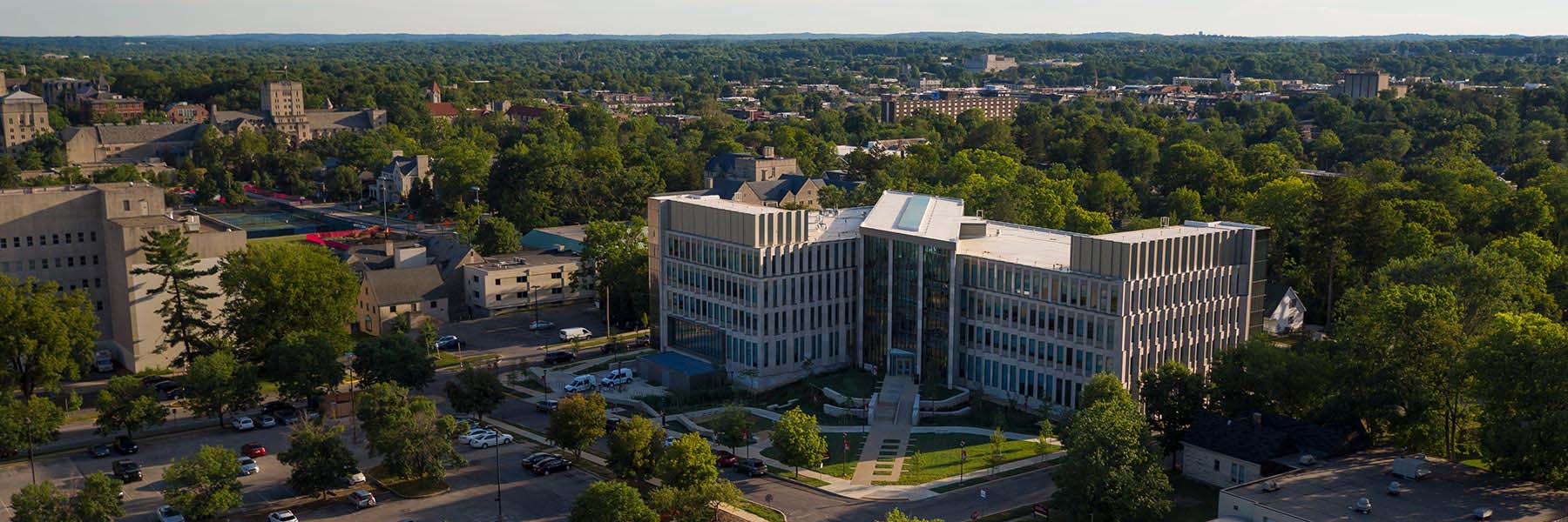 An aerial view of Luddy Hall in the summer; the trees are lush and green around it. 